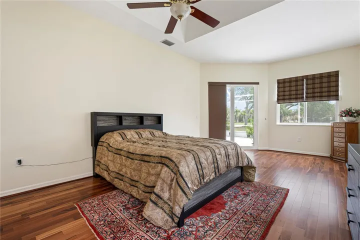 Huge Master bedroom with solid wood floors and view of lanai.