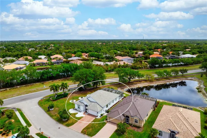 Drone view of the home looking northeast and pond view.
