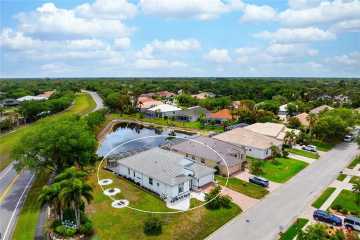 Drone view of the home looking southeast over pond.