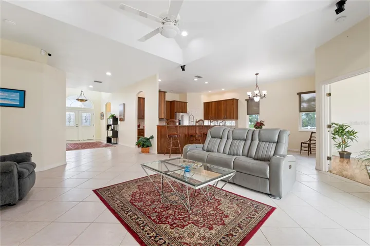 View from Living Room back to entrance hall with dining room and kitchen in background.