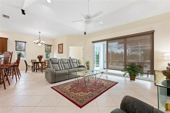 Living room with office and dining room in background. Some furniture for sale.