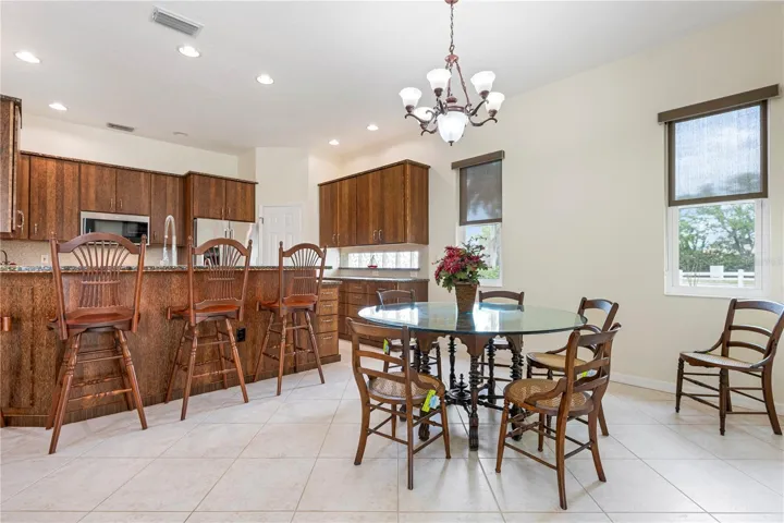 Dining room with kitchen in background. Furniture for sale here!