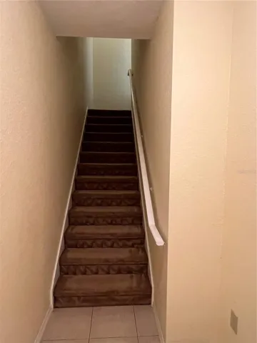 First floor indoor foyer and stairs to get up to unit.