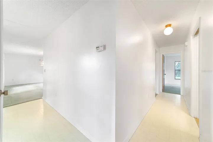 Hallway closet and hallway to primary bedroom and laundry room