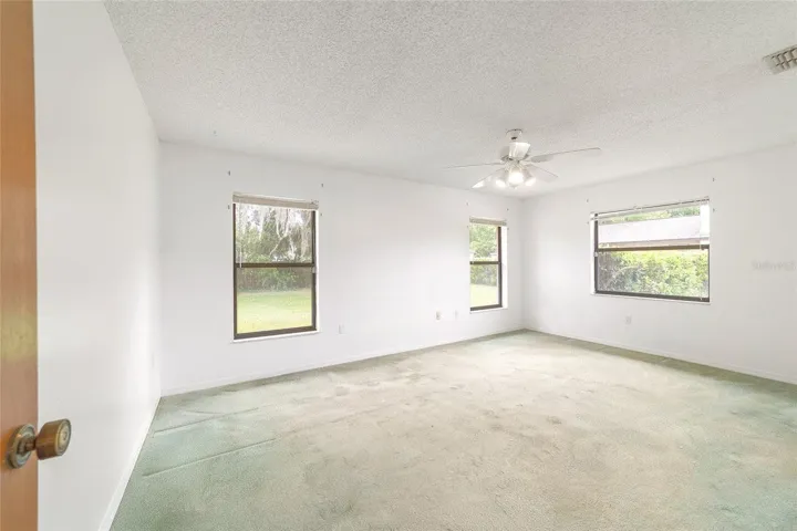 Primary bedroom with three windows