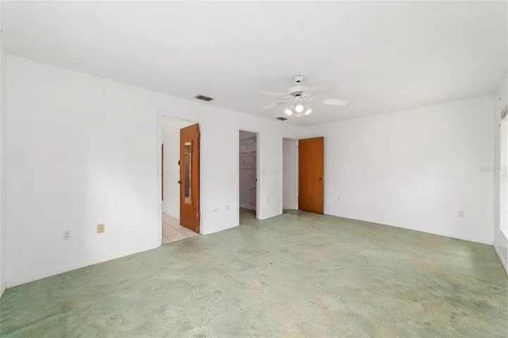 Primary bedroom walk-in closet