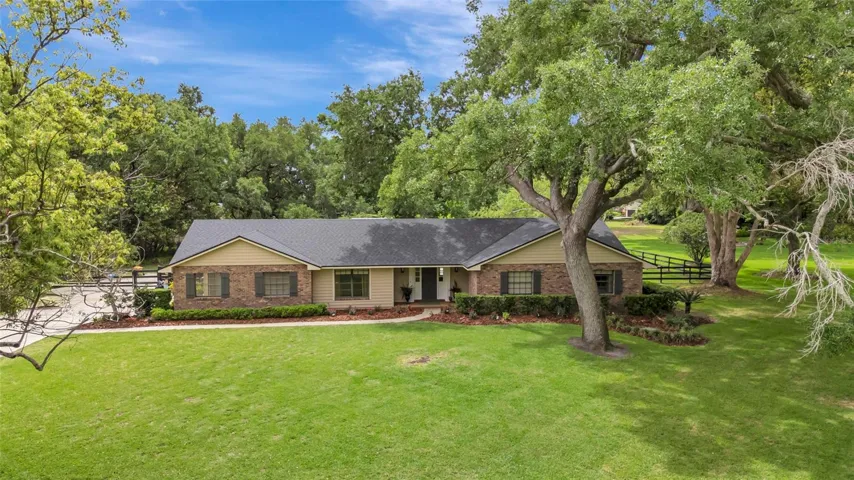Expansive one-acre homesite with sweeping lawn, mature trees, and exceptional privacy-no rear neighbors.