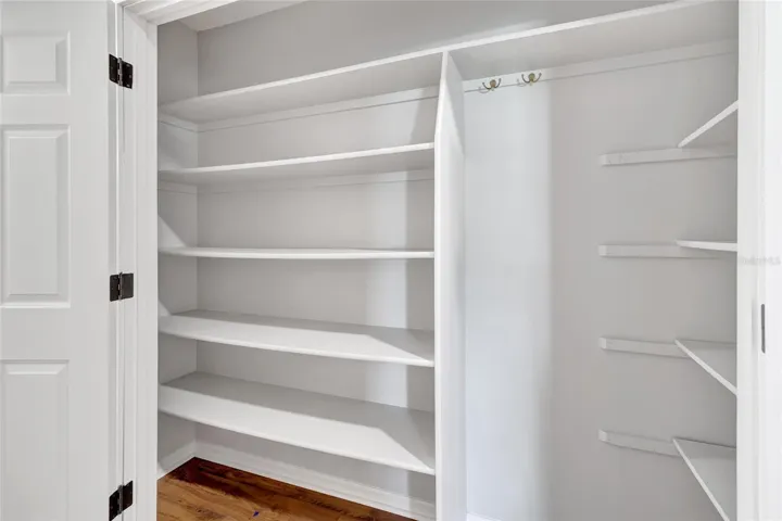 Additional hallway storage with built-in shelving- offering exceptional organization and extra space throughout the home.