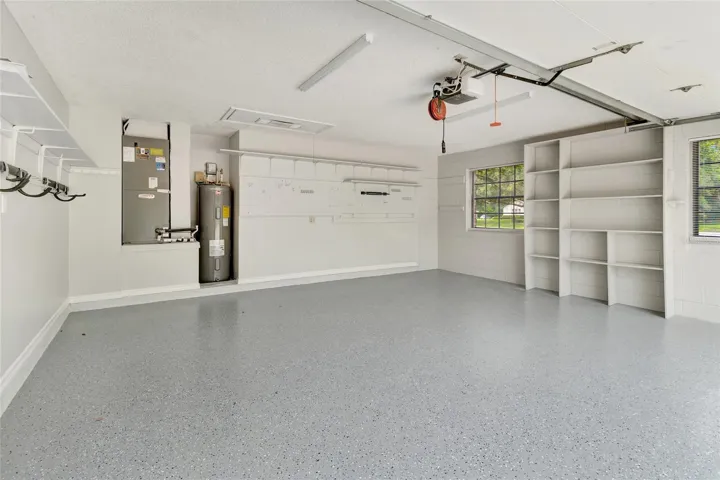 Oversized garage with upgraded flooring, built-in storage, and plenty of room for vehicles, tools, and hobbies!