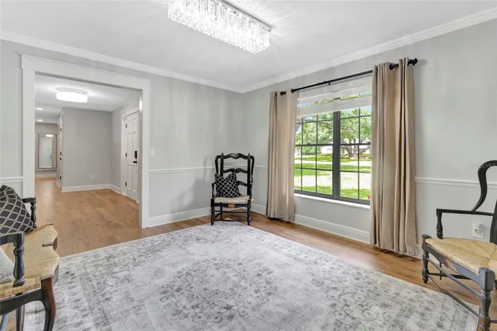 Versatile front room perfect as a formal dining area or elegant sitting room, filled with natural light and beautiful views.