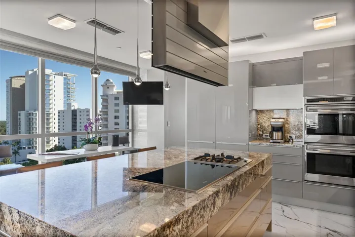 Oversized granite island with integrated breakfast bar