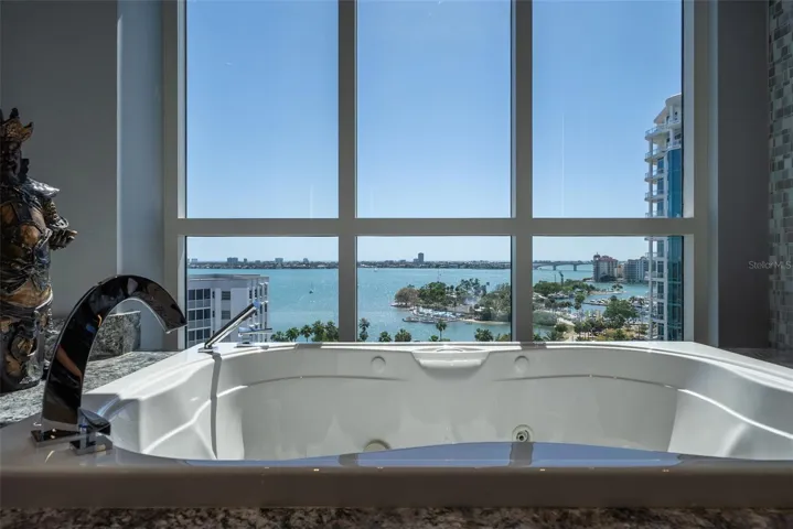 Free-form soaking tub positioned for tranquil relaxation