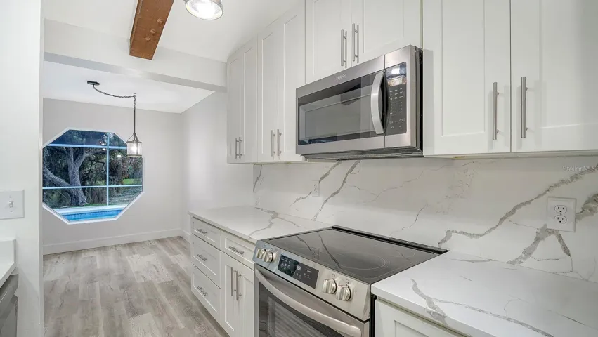 Newer Kitchen Cabinets, Quartz Tops and Backsplashes and Stainless Steel Appliances