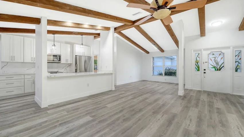 Great Room, Kitchen, Dining Room and Foyer all have a Vaulted Ceiling with Wooden Beams