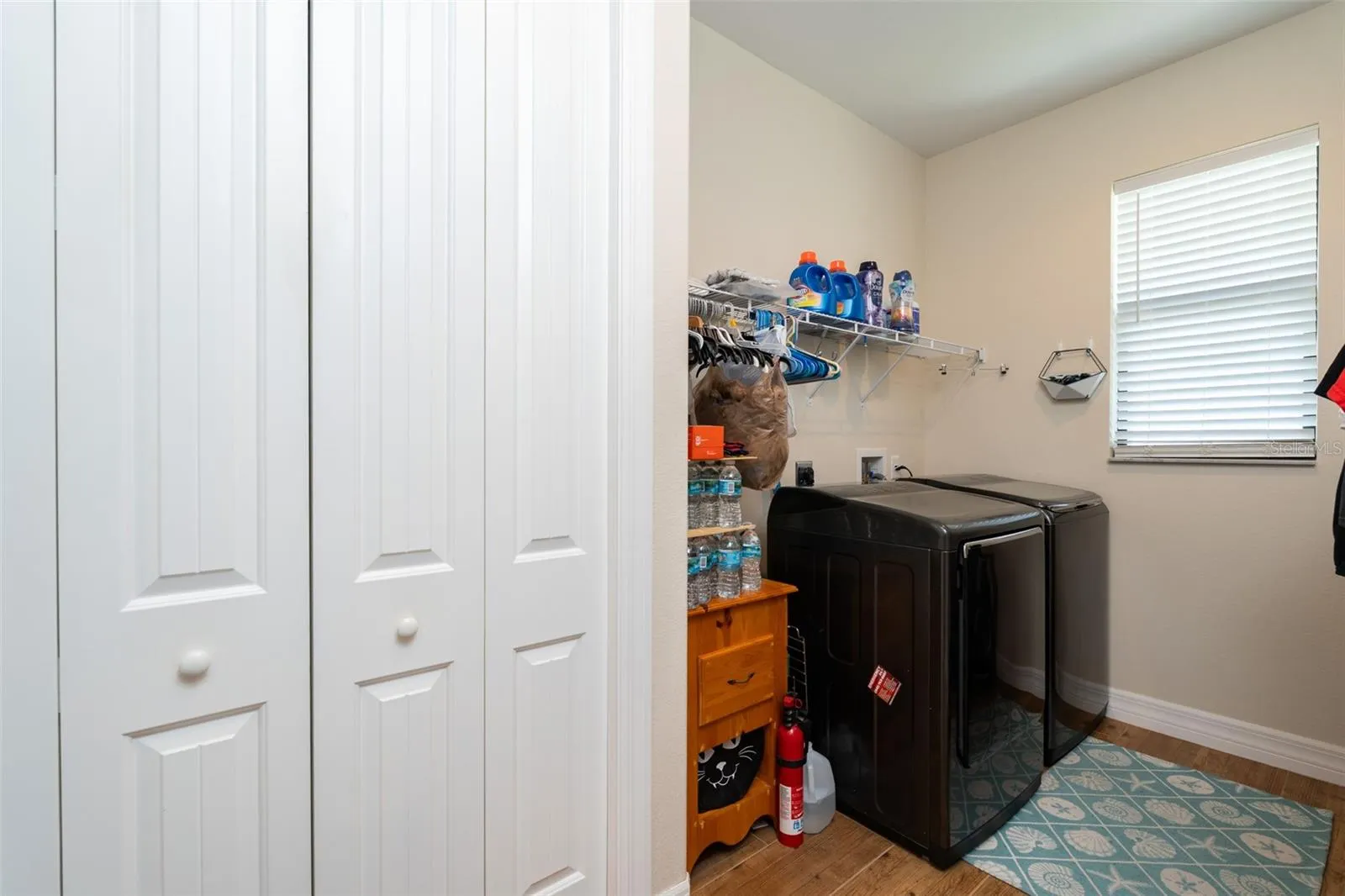 Laundry Room with large pantry closet and window