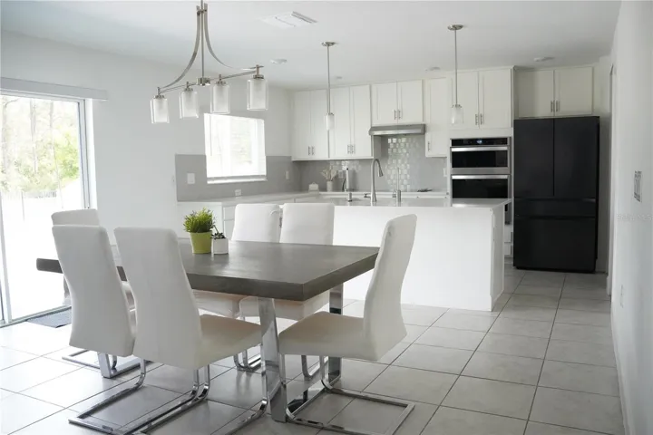 Open-concept layout connecting kitchen, dinning, and living areas.