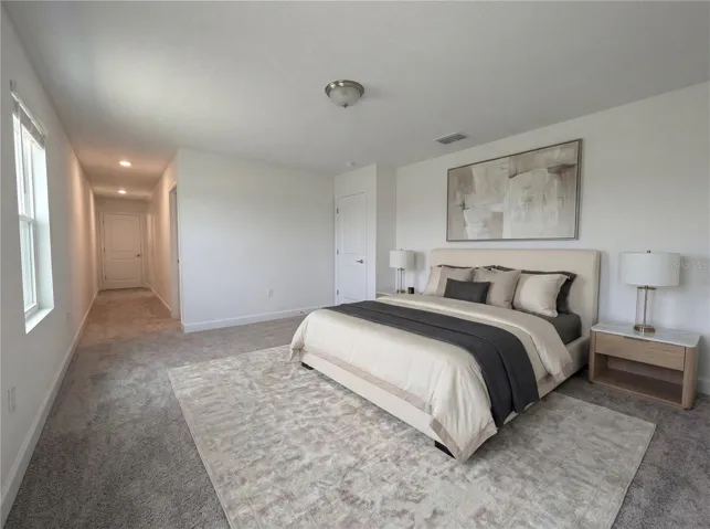 Spacious primary bedroom with natural light and peaceful ambiance.