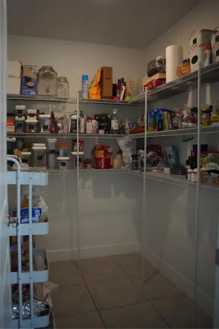 Walk-in pantry providing ample storage for kitchen organization.