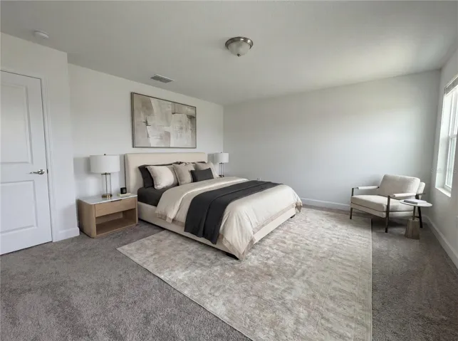 Spacious primary bedroom with natural light and peaceful ambiance.