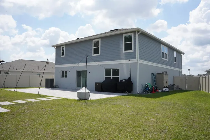 Rear exterior with spacious yard and sserene water