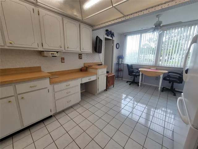 Kitchen features a dinetter which overlooks the courtyard and pool