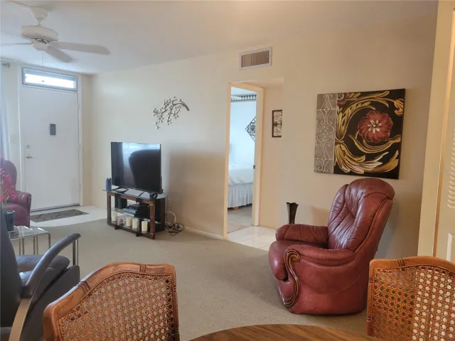 Living/Dining room with guest bedroom in background