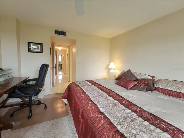 Hallway to walk-in closet and ensuite bathroom
