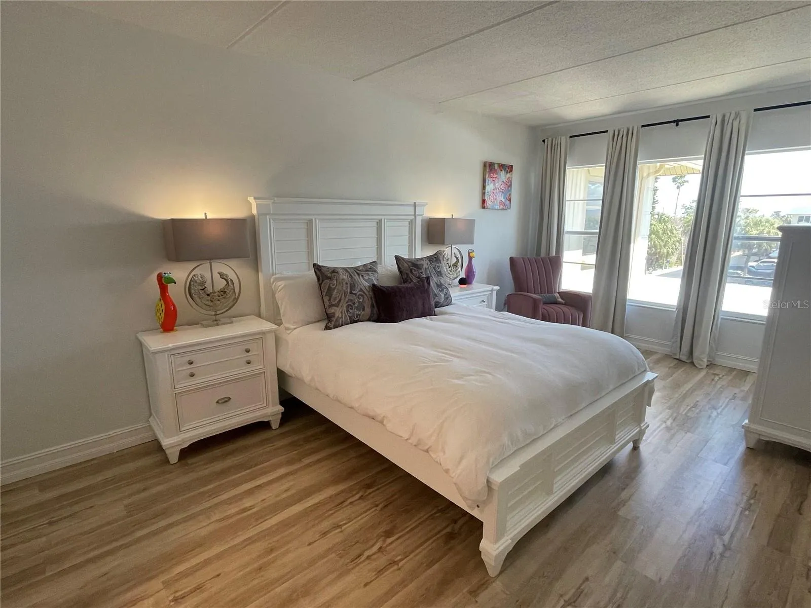 Primary bedroom with window curtains