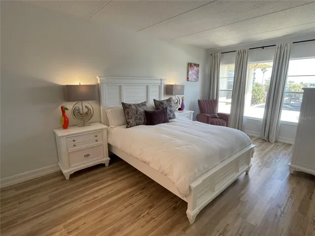 Primary bedroom with window curtains