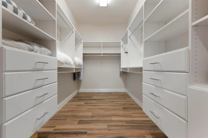 Primary walk-in closet with closet organization system