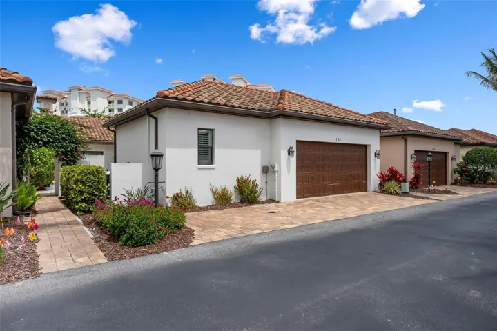 Rear two car garage, walkway with gated arbor to courtyard