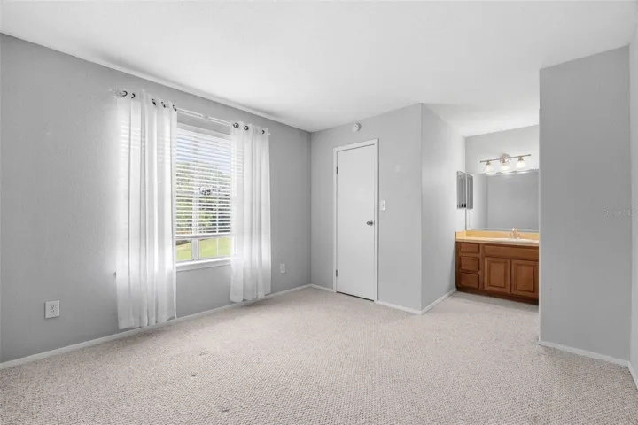 Primary Bedroom with window overlooking park-like setting