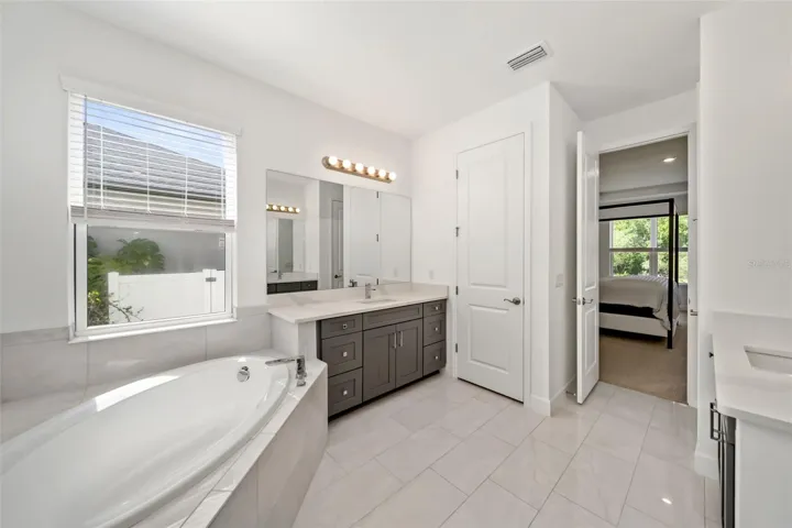 Primary Bath with separate garden tub and shower with seamless glass.