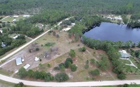 Top-down aerial of the lake highlighting its size, natural beauty, and proximity to the property