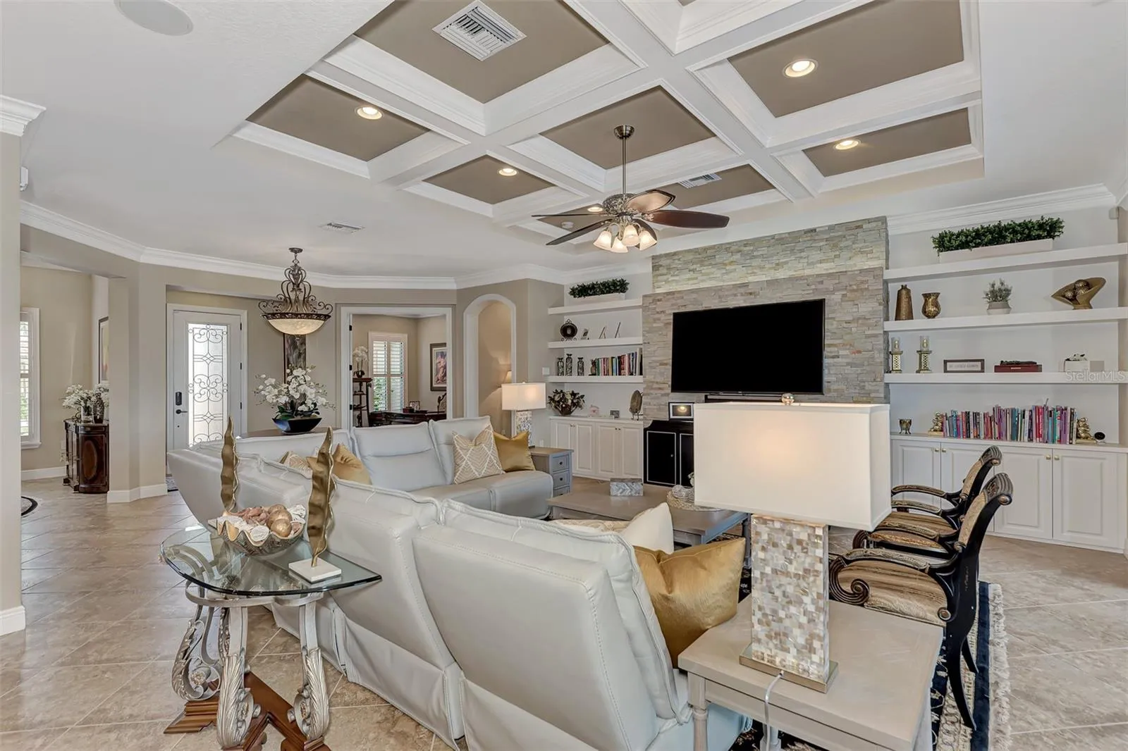 Hand designed and built beamed ceiling- master crafted by Fine-Line Carpentry - High end custom lighting and fans throughout the home.