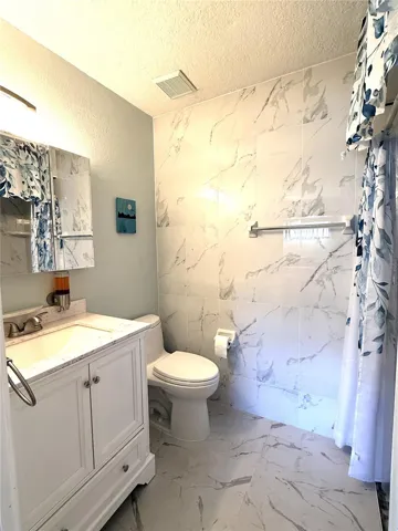Master Bath with upgraded Toto toilet and Mirrored Medicine Cabinet.