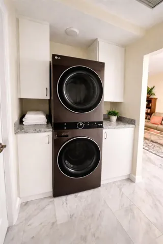 Modern Laundry area designed for stacking washer and dryer (negotiable) and plenty of storage.