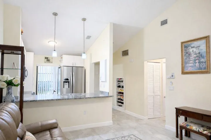 Kitchen offers a built-in phone charging and key storage cabinet.
