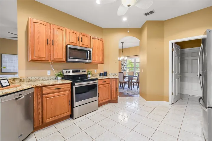 Kitchen with stone counters and newer appliances
