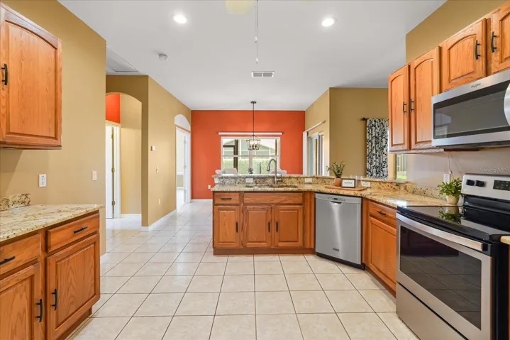 Kitchen with stone counters and newer appliances