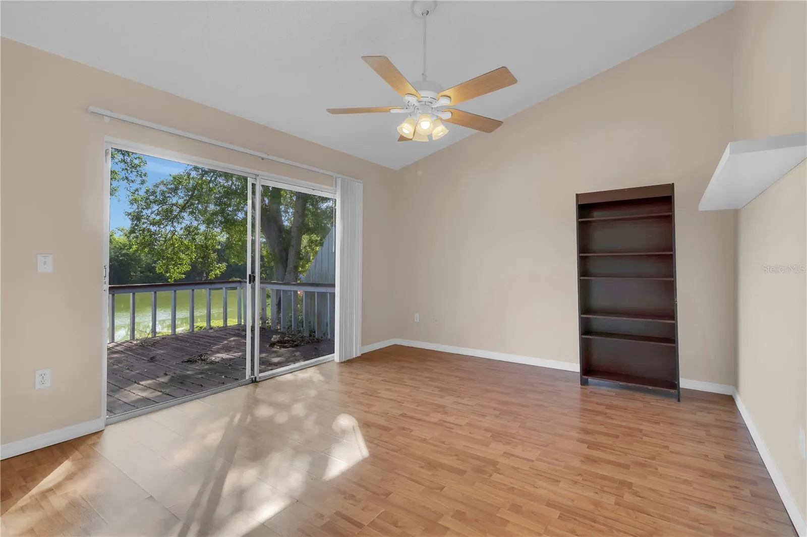 Primary bedroom with deck and lake views to wake up to.
