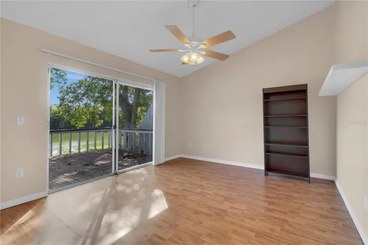 Primary bedroom with deck and lake views to wake up to.