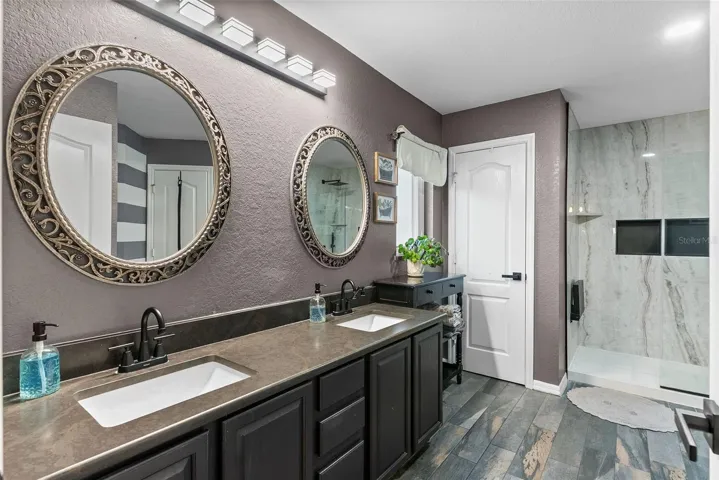 Master ensuite featuring a dual vanity and updated fixtures.