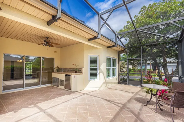Large screened in back porch with outdoor kitchen