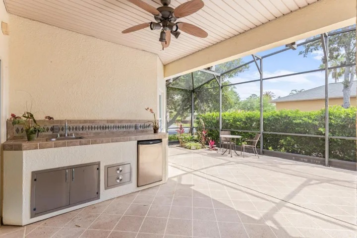 Large screened in back porch with outdoor kitchen