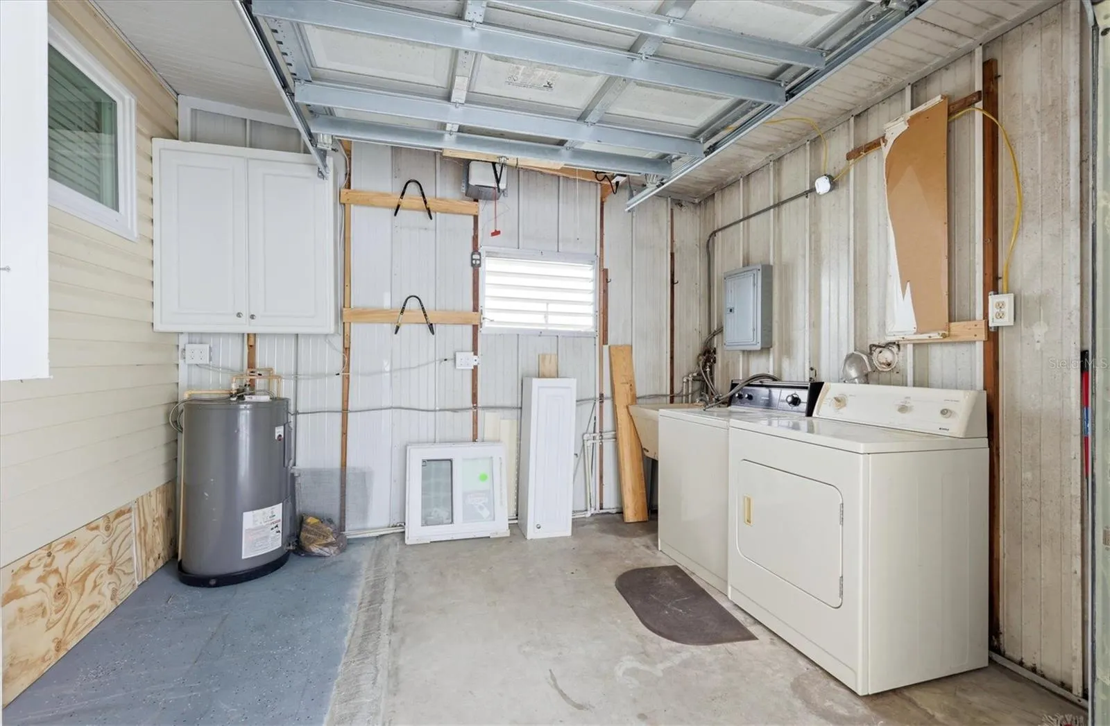 Shed/Laundry Room/Golf cart parking with garage door
