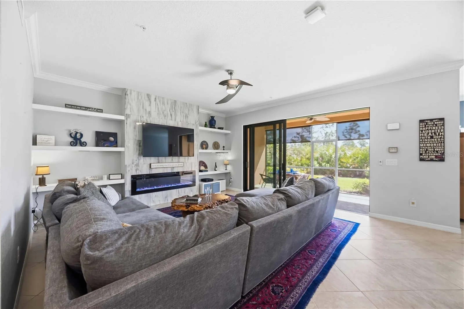 Living Room with Hurricane impact Sliders open to the Lanai.