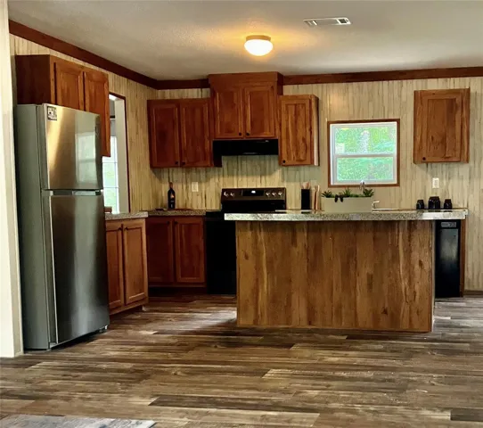 Stainless steel appliances. Large adjacent utility room is a perfect extension for pantry storage and additional appliances