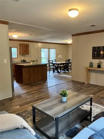 Livingroom, kitchen, and dining room are distinct spaces with a warm comfortable flow