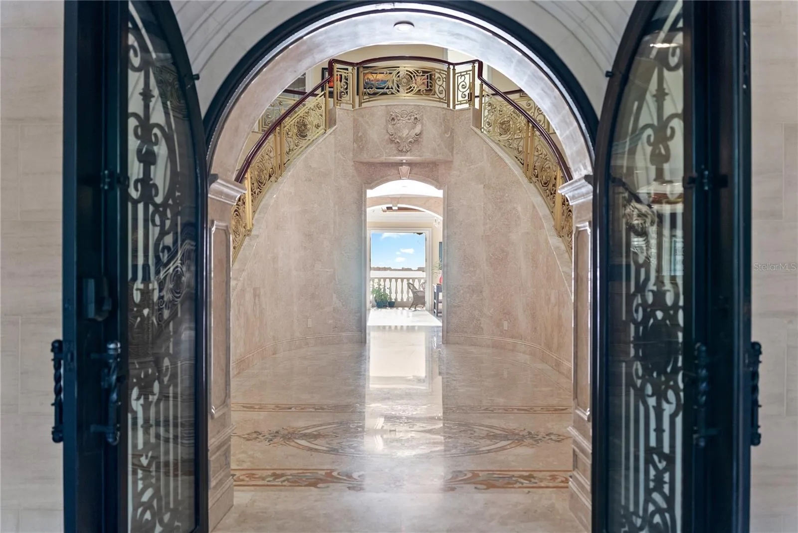 Arched Iron doors welcome you to Palazzo Sul Mare!   Opens to water views and a gallery corridor designed for art display and dramatic transitions between spaces.